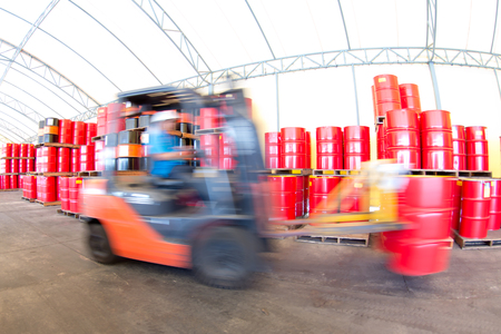 forklift handling the oil drum in ware houseの写真素材