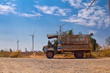 farmer truck with wind turbine backgroundの写真素材