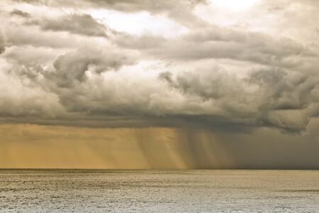 Storm clouds with rain over the sea