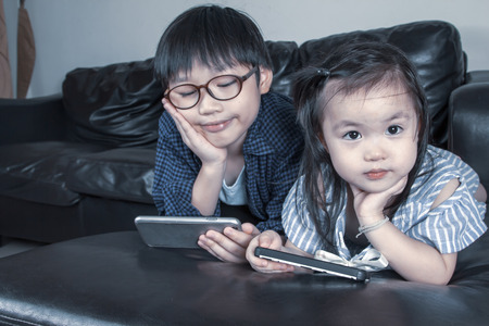 Happy boy and girl playing game online.の写真素材