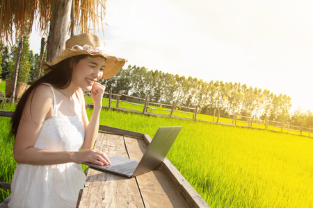 asian working woman using laptop, urban family on weekendの写真素材