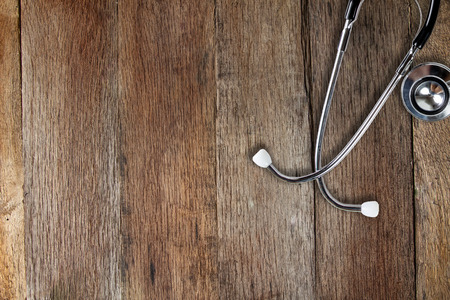 Stethoscope on wooden table form top view.の写真素材