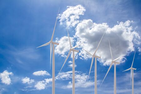 Windmill park, huge windmill generator turbines with blue sky on summer day.の写真素材
