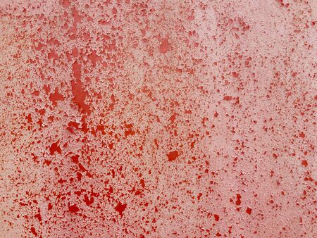Cracked old red paint on the wall.の写真素材