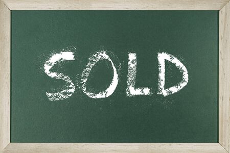 Word SOLD written on chalk board.の写真素材