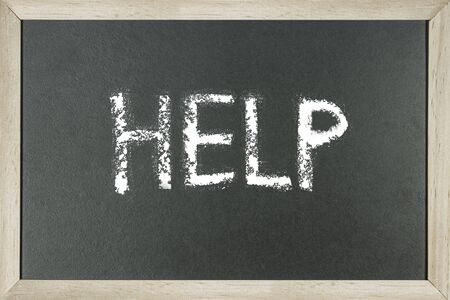 Word HELP written on chalk board.の写真素材