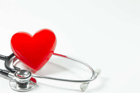 Red heart and a stethoscope on isolated white background.