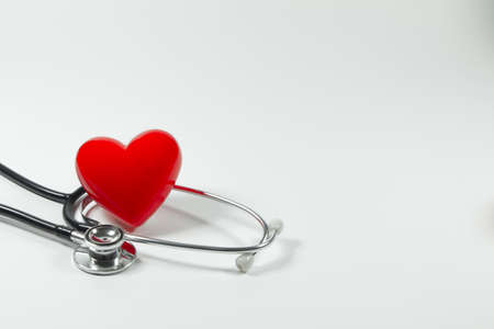 Red heart and a stethoscope on isolated white background.の写真素材