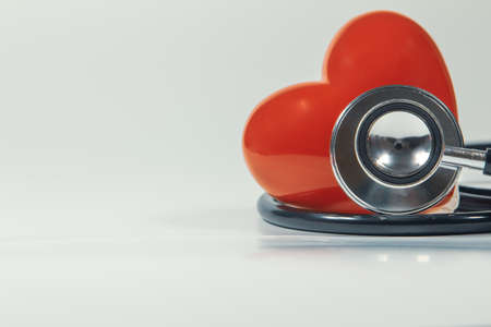 Red heart and a stethoscope on isolated white background.の写真素材
