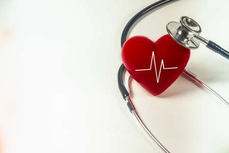 Red heart and a stethoscope on isolated white background.