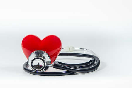 Red heart and a stethoscope on isolated white background.の写真素材