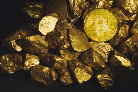Golden Bitcoin Coin and mound of gold. Bitcoin cryptocurrency. Business concept.の写真素材