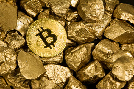 Golden Bitcoin Coin and mound of gold. Bitcoin cryptocurrency. Business concept.の写真素材