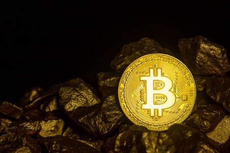 Golden Bitcoin Coin and mound of gold. Bitcoin cryptocurrency. Business concept.の写真素材
