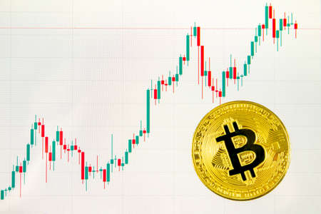 Bitcoins and New Virtual money concept.Gold bitcoins with Candle stick graph chart.Golden coin B.Mining or blockchain technologyの写真素材