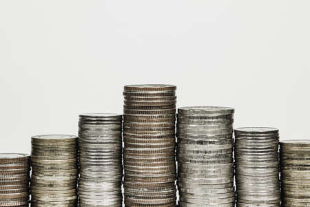Money,Financial, Business Growth concept Savings, increasing columns of stack coins on white background .の写真素材