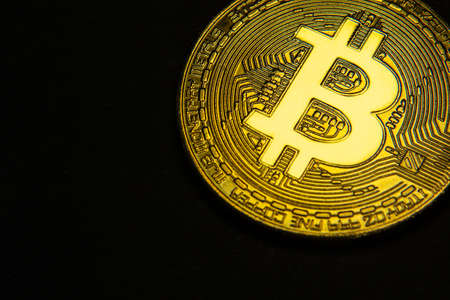 close up of golden bit coin on black background.の写真素材
