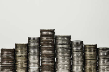 Money,Financial, Business Growth concept Savings, increasing columns of stack coins on white background .の写真素材
