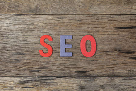 The word SEO is make from wood on wooden background.internet marketing ( search engine optimization) concept.の写真素材