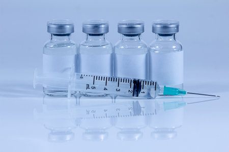 syringe and vaccine on white background.の写真素材