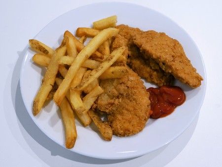 A plate of chicken tenders and french fries