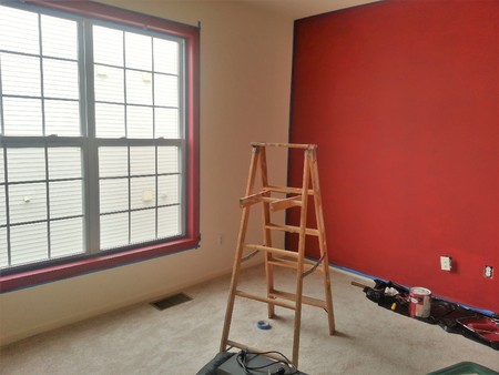Interior renovation with ladder, and freshly painted red wallの写真素材