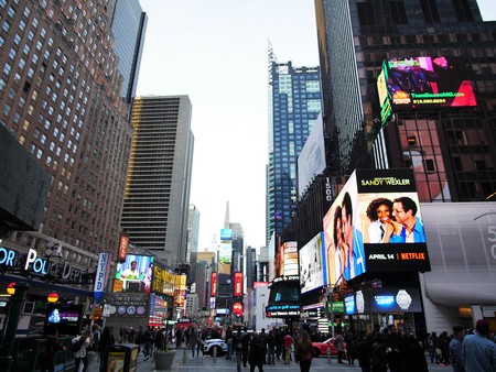 New York City - April 2 2017. Time Square, the crossroad of the world with crowds of people, street full of traffic and billboards.のeditorial素材