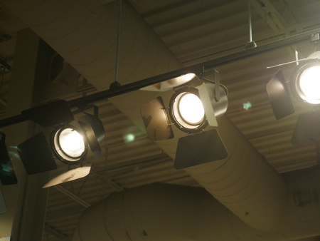 Set of spot lights on a rail hanging from the ceilingの写真素材