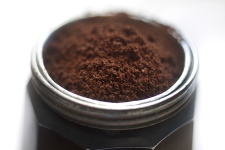 close up studio shot of aged italian mocha full of melted coffe  on light grey background の写真素材