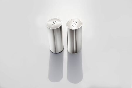 catering equipment for salt and pepper in the restaurant on the sun on tableの写真素材