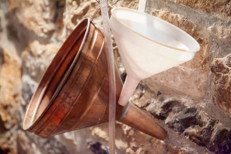 Two funnels on the wall in the pit which is also a wine cellar