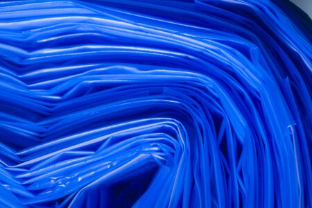 part of a roll of plastic garbage bags in blue colorの写真素材