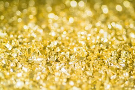 smal pieces of gold on the surface with a focus at the border of the lower third the rest of the...