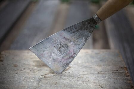 Dirty Painting Spatula Pinned in Workbench During Work Pauseの写真素材
