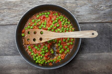 Studio Shot of Green Beans in Tomato Sauce on Decayed Wood Background