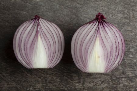 Two Half Cut Red Onion on Decayed Wooden Background