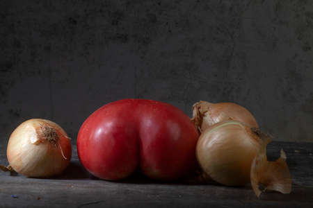 Still Life Photo of Tomatoes With Onions on Decayed Wooden Backgroundの写真素材
