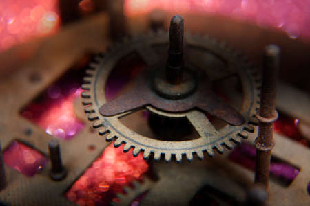 Macro Photo of Part of Rusted Rotten Clock Mechanism on Pink and Purple Backgroundの写真素材