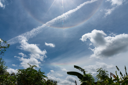 sun halo blue sky and cloudsの写真素材