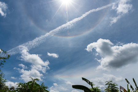 sun halo blue sky and cloudsの写真素材