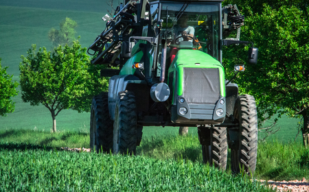 tractor on the field eco background. Summer hill amazing paysage wallpaper. South Moravia, Czech Republicの写真素材