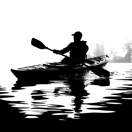 Silhouette of a man in a kayak on the lakeの素材