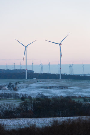 Wind turbines on a snowy field in winter. Alternative energy sources. Germany, Frankfurt