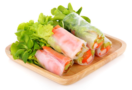 Vegetable salad in wooden plate on the wooden table.