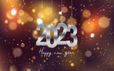 Happy New Year 2023. Hanging metal number on an out of focus colorful bokeh background.