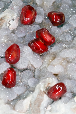 Red graines pomegranate on stone の写真素材