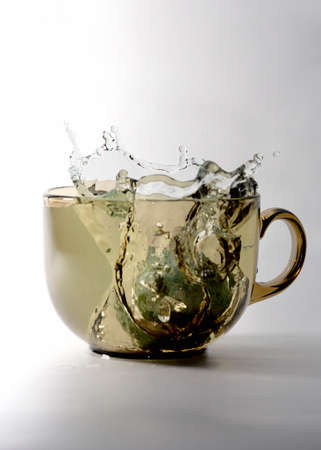 Splashes, drops and waves in glass closeupの写真素材