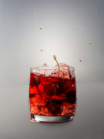 Cocktail in glass with vodka, cherryberries and iceの写真素材