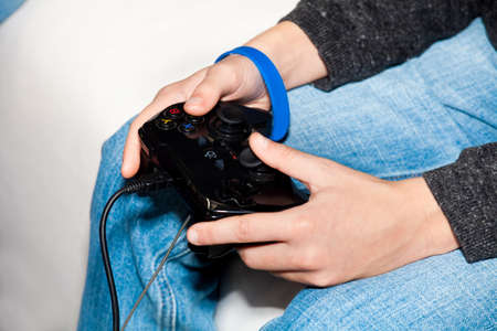 Video game controller in man handsの写真素材