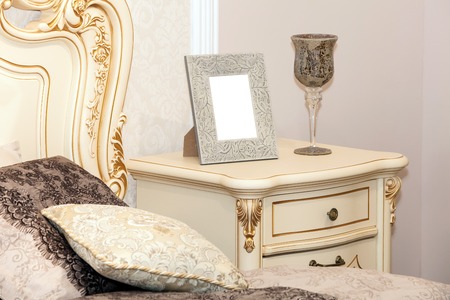 Blank photo frame on the chest of drawers. Mock up of blank photo frameの写真素材